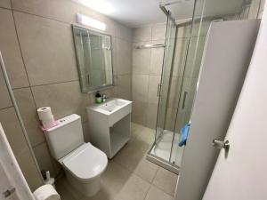 a bathroom with a shower and a toilet and a sink at Alex Beach Apartment 203 in Larnaka +78 photos