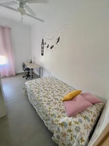 a bedroom with a bed and a table and a ceiling at Apartamento ZAPILLO IRIA 1 in Almería