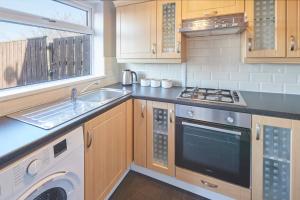 a kitchen with a sink and a stove top oven at Host & Stay - Armitage Road in Redcar