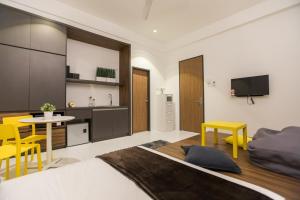a bedroom with a bed and a table and chairs at ALOR SETAR IMPERIO PROFESSIONAL SUITE by Zenith Smart in Alor Setar