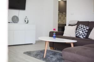 a living room with a couch and a table at Serious Job Apartment in Dubrovnik