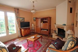 ein Wohnzimmer mit einem Sofa und einem Kamin in der Unterkunft Le val des deux rieux in Saint-Just-le-Martel