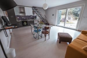a kitchen and living room with a table and chairs at A casa di Luciana in Viterbo