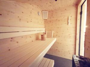 a sauna with a bench in a wooden room at Panorama Lodge Edelweiss in Gosau