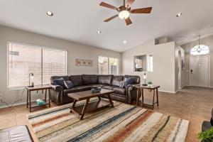 a living room with a couch and a ceiling fan at Emile Zola Peoria home in Peoria