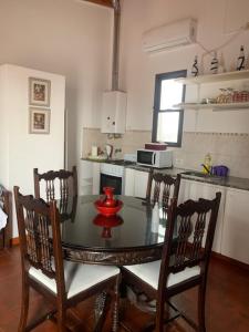 a kitchen with a glass table with chairs and a kitchen gmaxwell gmaxwell gmaxwell at Departamento Centrico in Concordia