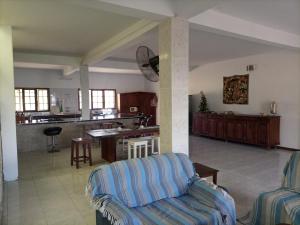 a living room with a couch and a kitchen at Sea and sun in Cidade de Nacala