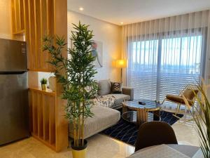 a living room with a couch and a table at Mogador Presidential Terrace - By AppartAli in Casablanca