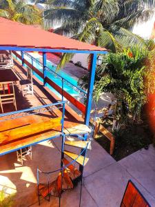 a wooden bench sitting next to a blue railing at Hotel Chuburna in Chuburná