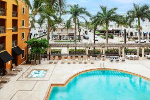 una vista aérea de una piscina en un hotel con palmeras en The Atlantic Suites on the Ave, en Delray Beach