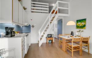a kitchen and dining room with a staircase in a loft at 3 Bedroom Cozy Apartment In Ringkøbing in Ringkøbing