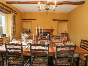 a dining room with a wooden table and chairs at Manor House in Leyburn