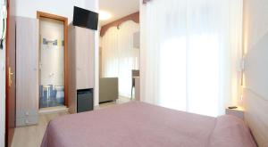 Postel nebo postele na pokoji v ubytování Hotel Da Mario
