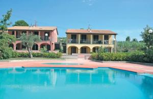 a large swimming pool in front of a house at Baia Fiorita in Porto Azzurro