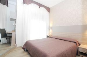 Postel nebo postele na pokoji v ubytování Hotel Da Mario