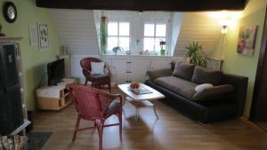 a living room with a couch and a table at Ferienwohnung Schindler mit Balkon in Merkendorf
