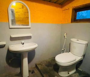 a bathroom with a toilet and a sink at Vitamin Sea Beach Cabana in Nilaveli +36 photos