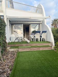 grupa krzeseł i stołów na patio w obiekcie AS22947-Studio cabine résidence direct sur plage w mieście Le Grau-du-Roi