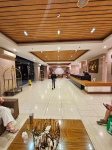 a lobby with a person walking in the middle of a building at Tagaytay Nordic Nest Staycation at Wind Residences with Netflix Wifi near Sky Ranch in Tagaytay +25 photos