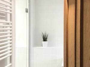 a plant in a white pot on a shelf in a room at Ebbas Neuk in Beadnell