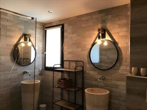ein Badezimmer mit zwei Waschbecken und zwei Spiegeln in der Unterkunft Sweet Holiday in Porto-Vecchio