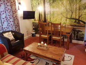 a living room with a wooden table and chairs at No6 High Street in Edwinstowe