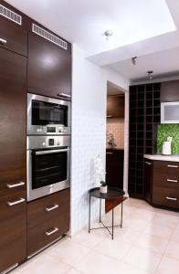 a kitchen with stainless steel appliances and a table at ClickTheFlat Piękna Center Apart Rooms in Warsaw