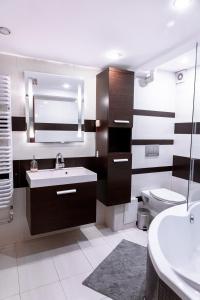 a bathroom with a sink and a toilet at ClickTheFlat Piękna Center Apart Rooms in Warsaw