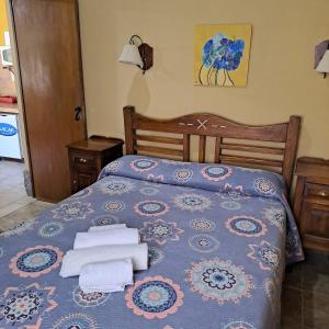 a bedroom with a bed with towels on it at Cabañas SHAMBALLA in Cafayate