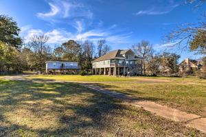 a large house on a grass field with a driveway at Coden Vacation Rental with Bay Access! in Coden