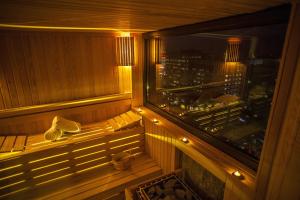 a sauna with a view of a city at night at Surmeli Istanbul Hotel in Istanbul