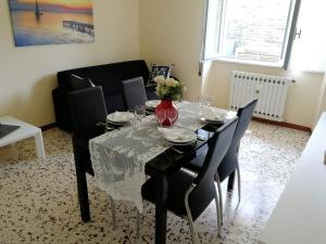 a dining room with a black table and chairs at Casa dolce casa, a 2 passi dal lago e vicina a Varenna in Lierna +38 photos
