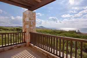 a balcony with a view of the ocean at The Westin Resort, Costa Navarino in Romanu