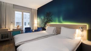 a hotel room with a large bed and a large window at Thon Hotel Nordlys in Bodø