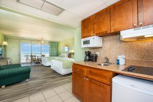 a kitchen and living room with a view of a living room at The Schooner Inn in Virginia Beach