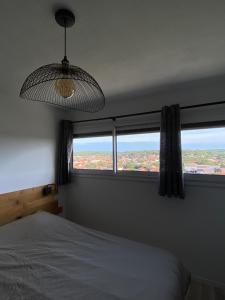 a bedroom with a bed and a large window at Sunset lovers in Lacanau-Océan