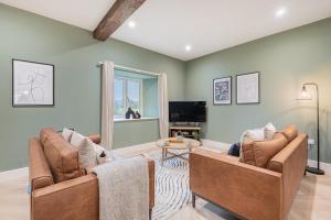 a living room with two chairs and a table at Willow, a luxury rural retreat in Staveley