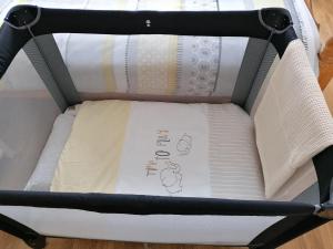 a baby crib with a mattress in it at Atlantic Way Farmhouse in Lahinch