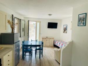 a kitchen and dining room with a table and chairs at Mimi Leuca B&b in Leuca