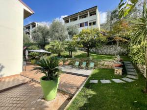 a garden with chairs and a building at Casa Tuly in Brenzone sul Garda