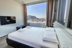 A bed or beds in a room at Majestic Acropolis-Lycabettus