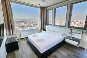 A bed or beds in a room at Majestic Acropolis-Lycabettus