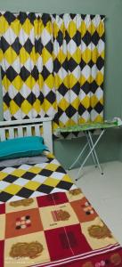 Una cama o camas en una habitación de Homestay Lumut Perak