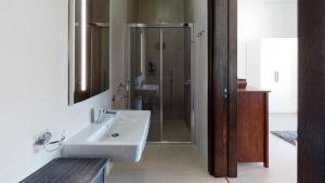 a white bathroom with a sink and a shower at St Julians Central luxury apartment in St. Julianʼs +14 photos