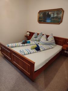 a bed with a wooden frame in a bedroom at Wohlfühl - Appartement Fewo Pichlarn Irdning Ferienwohnung in Aigen im Ennstal