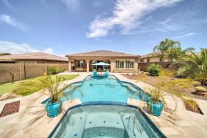 uma piscina no quintal de uma casa em Upscale Goodyear Home with Resort-Style Pool and Spa! em Liberty