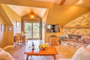 a living room with a table and a fireplace at Romantic YosemiteandBass Lake Retreat with Mtn Views! in North Fork