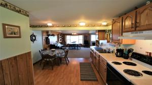 a kitchen with wooden cabinets and a dining room at Sunset Shore in Petoskey