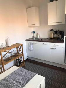 a kitchen with white cabinets and a counter top at Kaksio lähellä rantaa in Pärnu