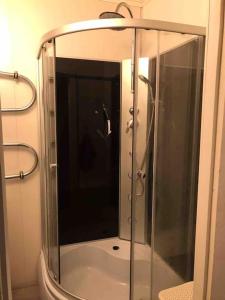 a shower with a glass door in a bathroom at Kaksio lähellä rantaa in Pärnu +13 photos